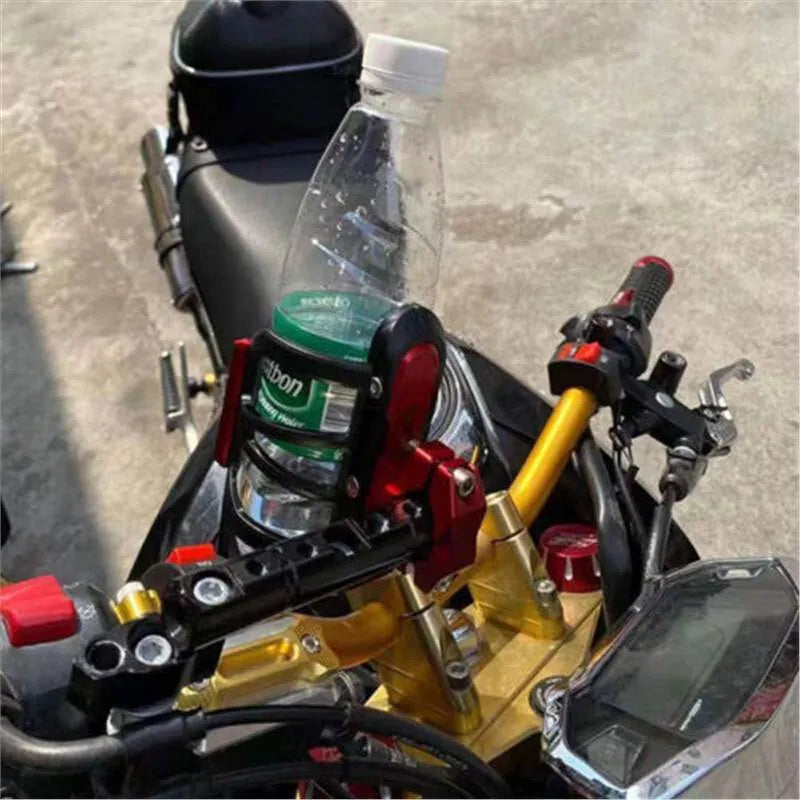 Black water bottle cage mounted on the bumper of a Honda X-ADV scooter