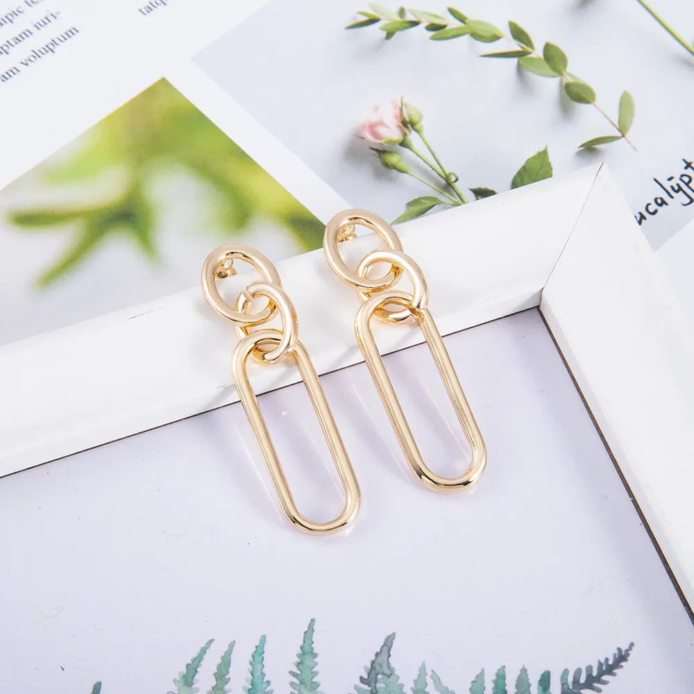 Sterling silver geometric hoop earrings with needle posts and ring-line design