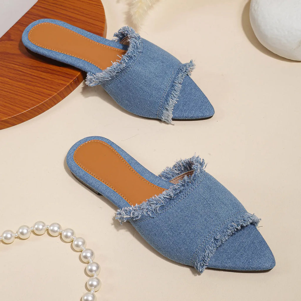 Women's denim flat slippers with a tassel detail and leather lining, shown in apricot colour.