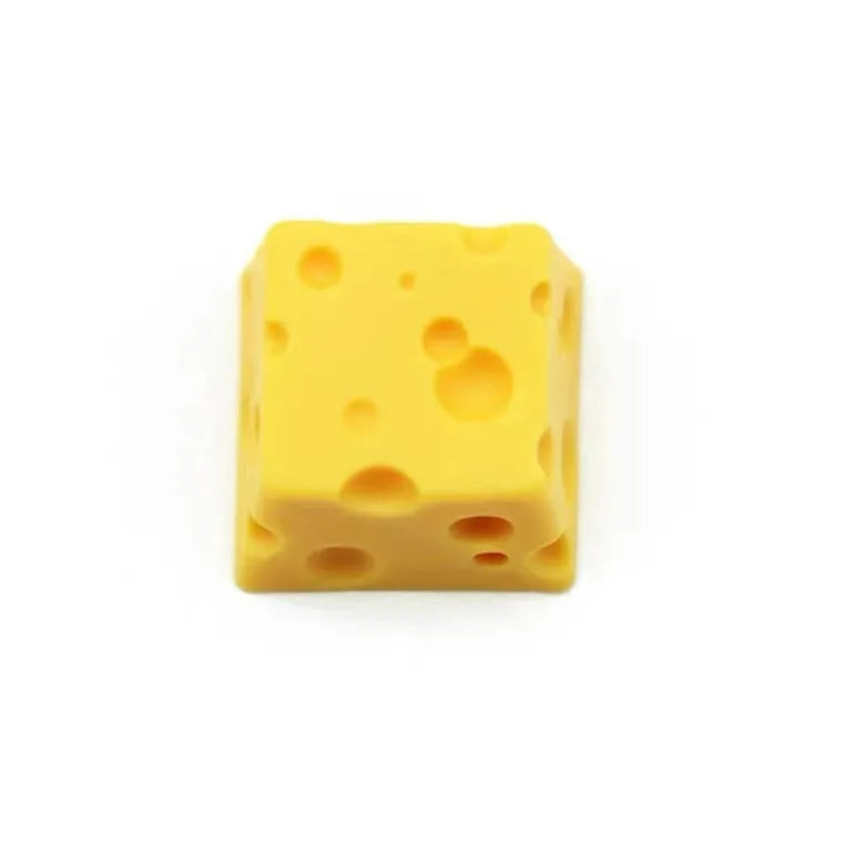 Close-up of a yellow solid resin cheese-themed keycap for mechanical keyboards.