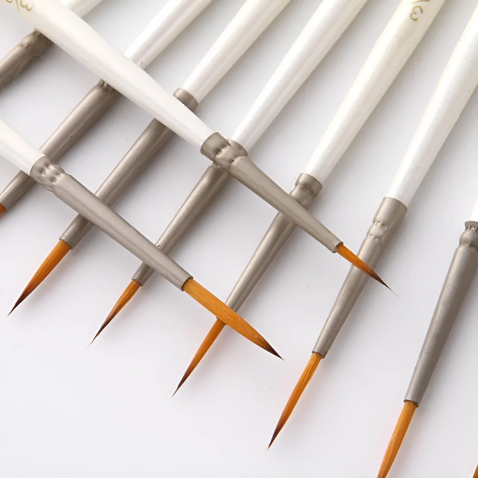 Set of twelve pearl white fluorescent marker pens with nylon wool brush tips for artists.