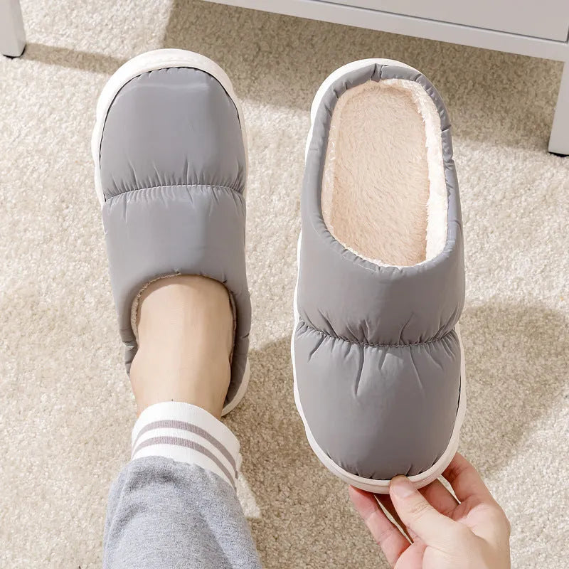 A pair of down cotton slippers with an artificial leather upper and thick rubber sole, shown in blue.