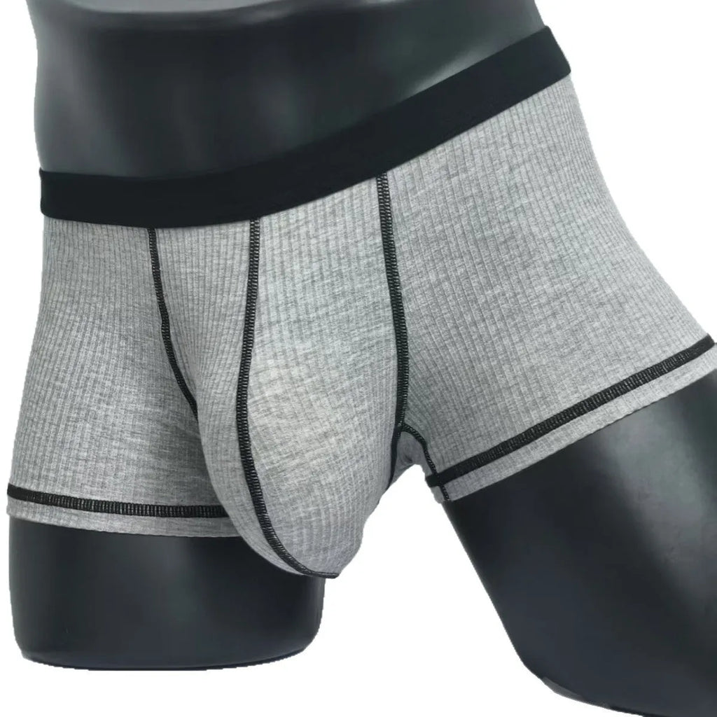 Men's solid-colour fibre boxer shorts on a white background showing hip-lifting design.