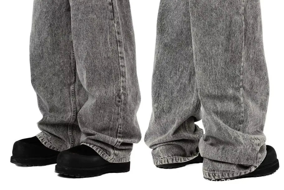 Grey loose straight-leg denim trousers for men and women on a neutral background