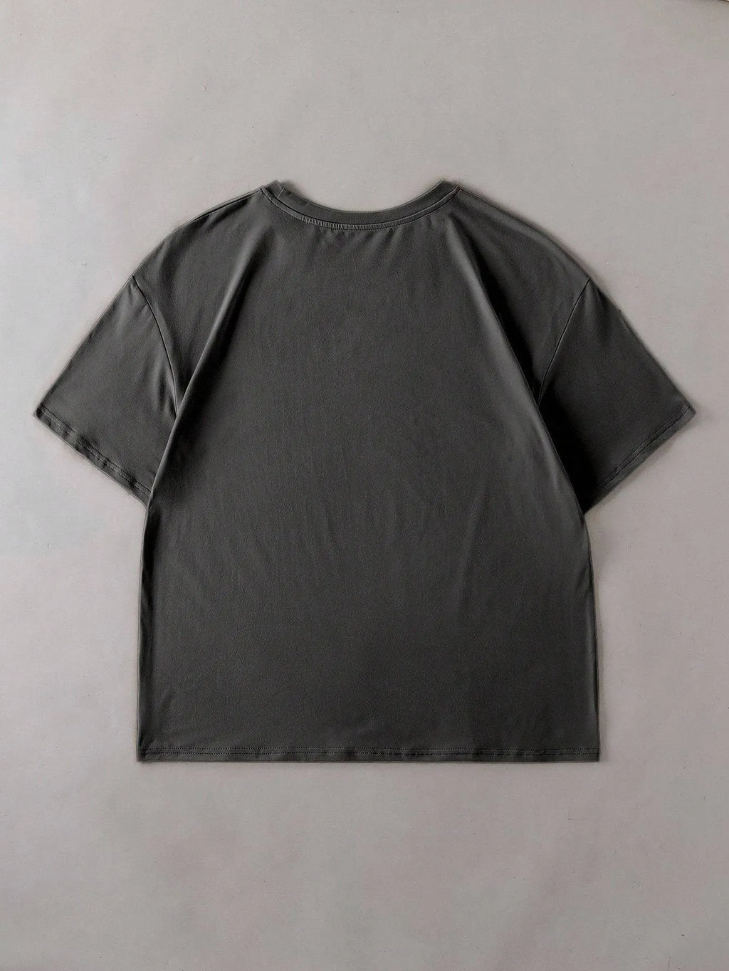 Loose-fit cotton summer T-shirt on a hanger, showing short sleeves and round neck in grey