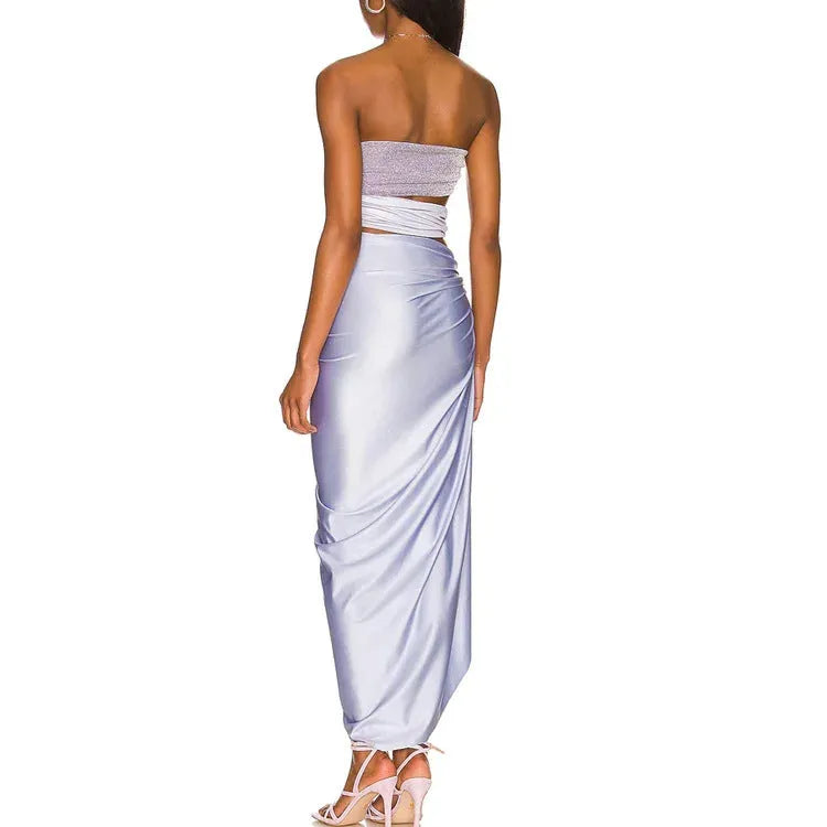 Purple one-piece swimsuit with hollow design and matching wrap skirt on a model.
