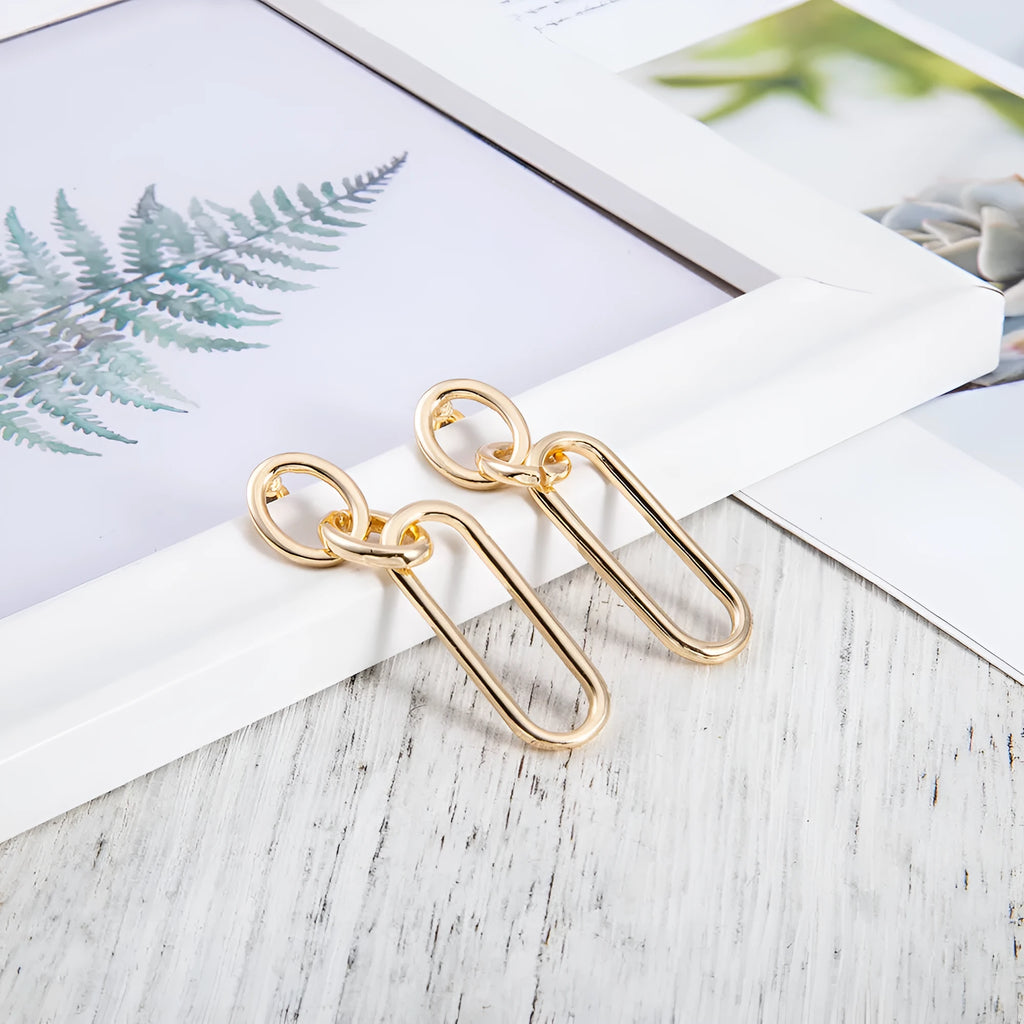Sterling silver geometric hoop earrings with needle posts and ring-line design