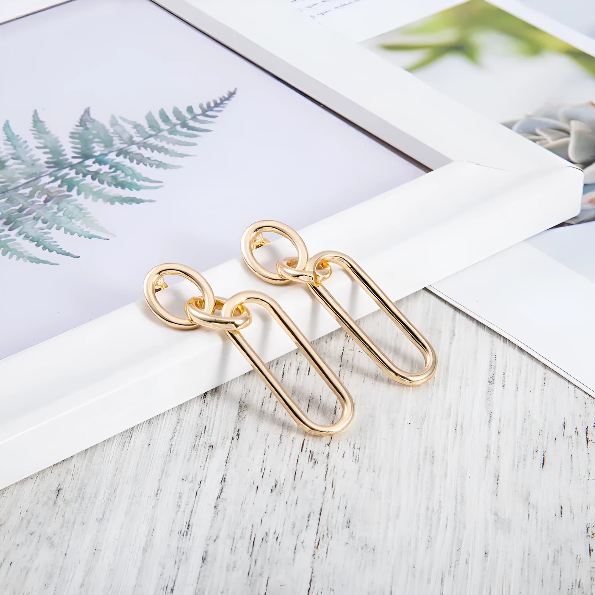 Sterling silver geometric hoop earrings with needle posts and ring-line design