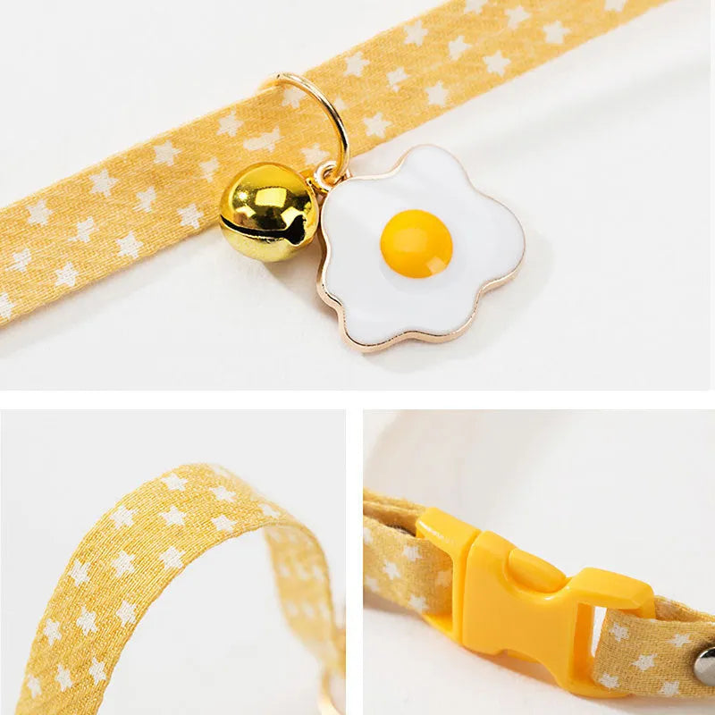 Green adjustable cat collar with a silver bell and a matching bow tie on a white background