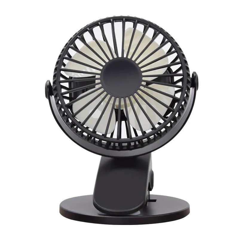 White clip fan with plastic blades attached to desk edge