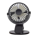 White clip fan with plastic blades attached to desk edge