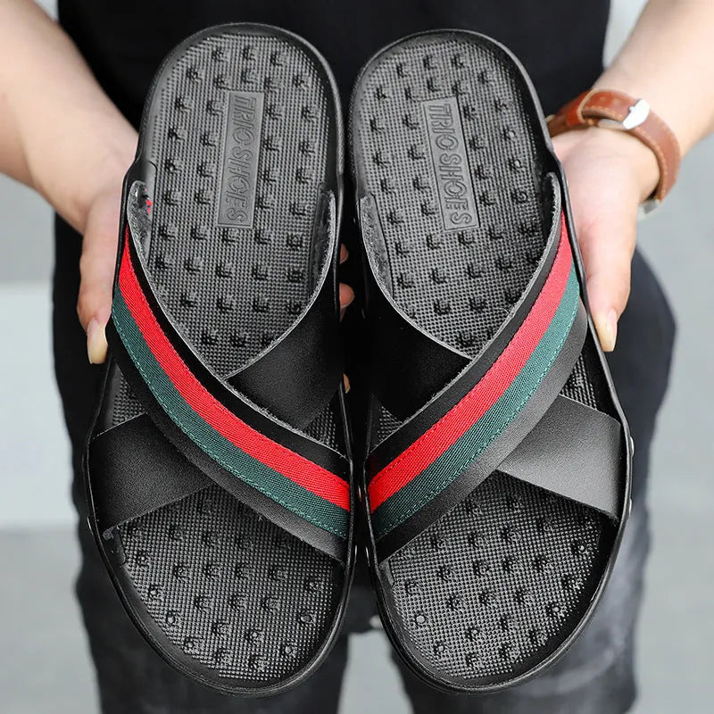 Men's cowhide leather flip-flops on a beach, showing black, blue and white colour options