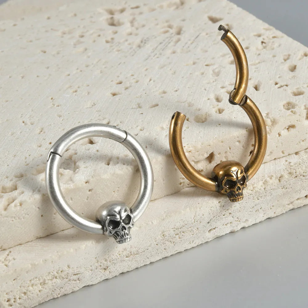 Copper punk earrings with embossed ghost head designs in antique gold and silver finishes
