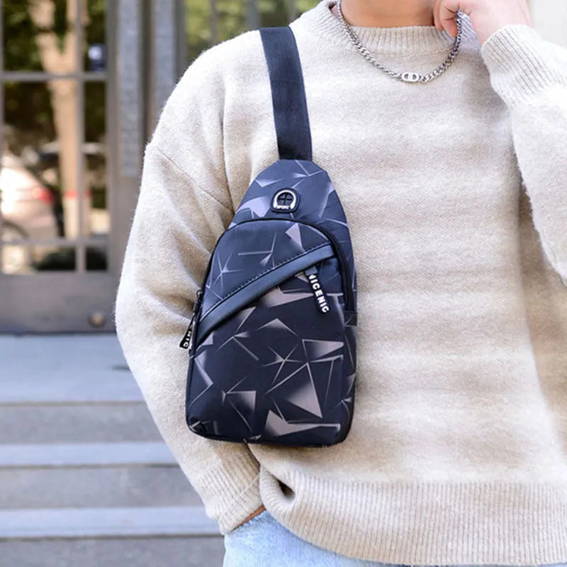 Black Oxford cloth crossbody chest bag for men with a visible earphone hole and zipper.