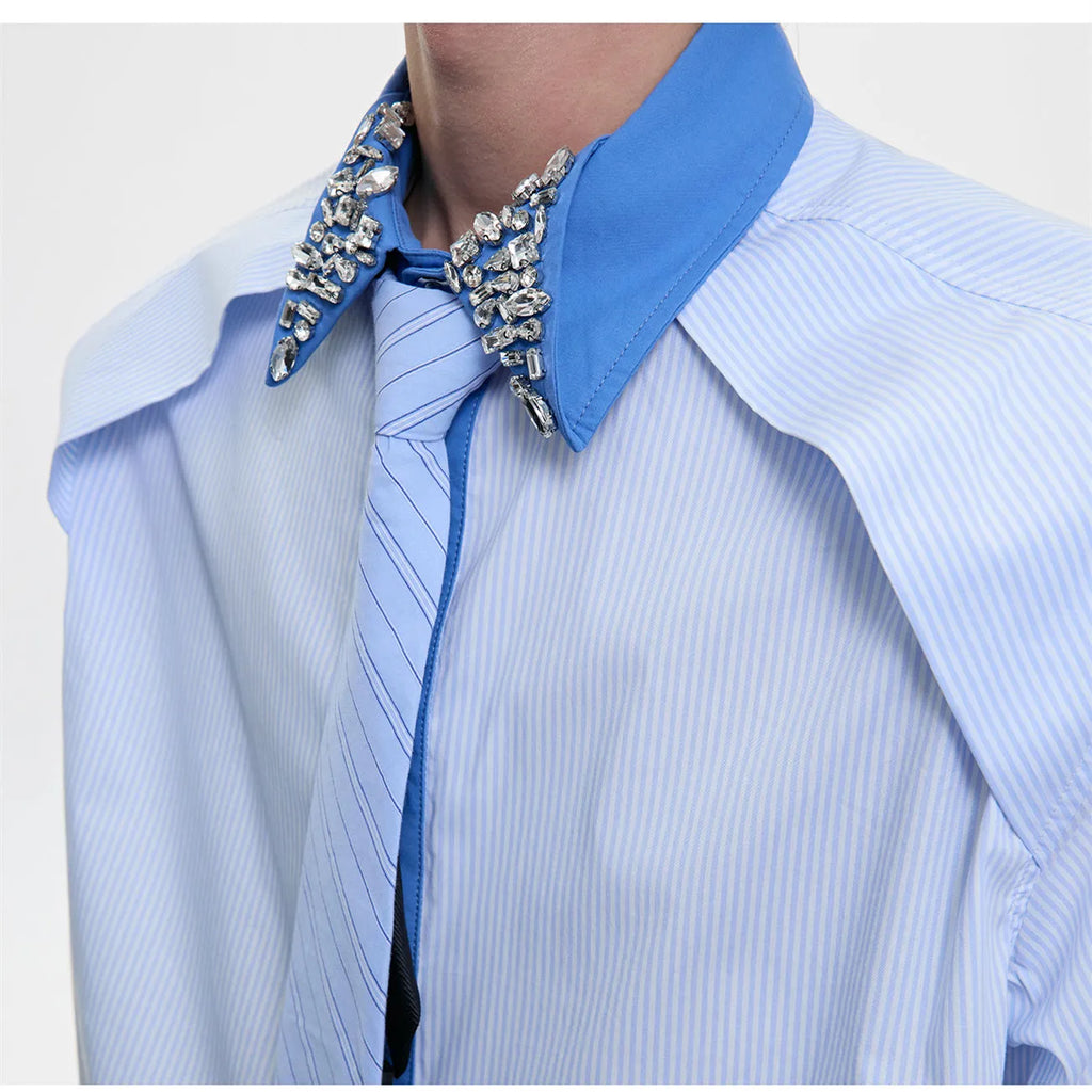 Men's blue and khaki patchwork striped shirt with diamond tie and quilted details, showing loose fit and flip collar.