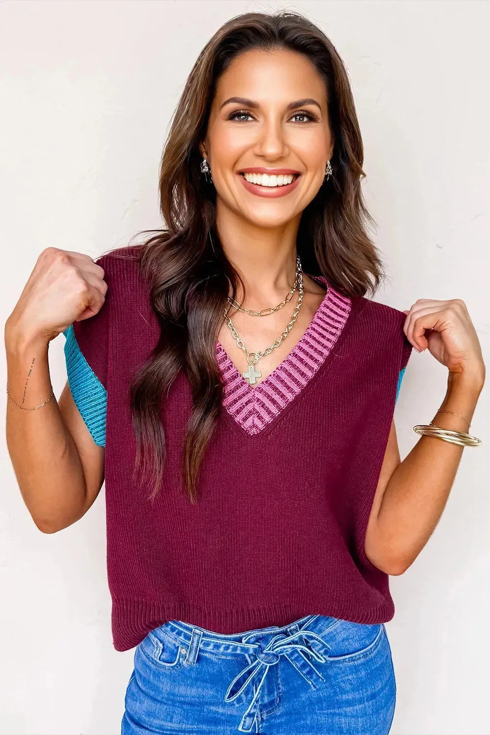 Burgundy loose-fitting V-neck sweater with contrast trim detail on cuffed short sleeves.