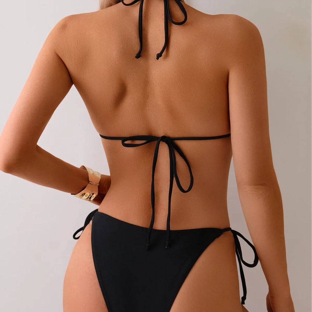 Black women's bikini swimsuit with split front and silver metal bead decoration.