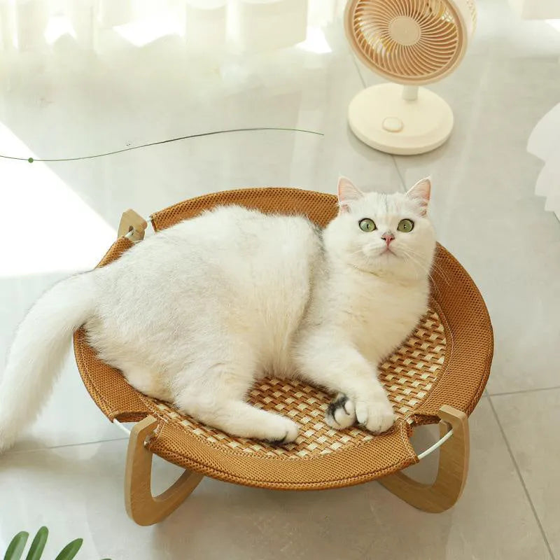 Brown woven rattan square pet hammock bed for cats and dogs, elevated off the ground.