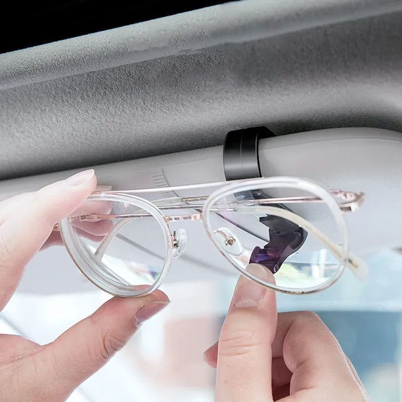 Black plastic car sunshade clip for holding glasses, tickets and ID cards, dimensions 6.5 by 2.3 centimetres