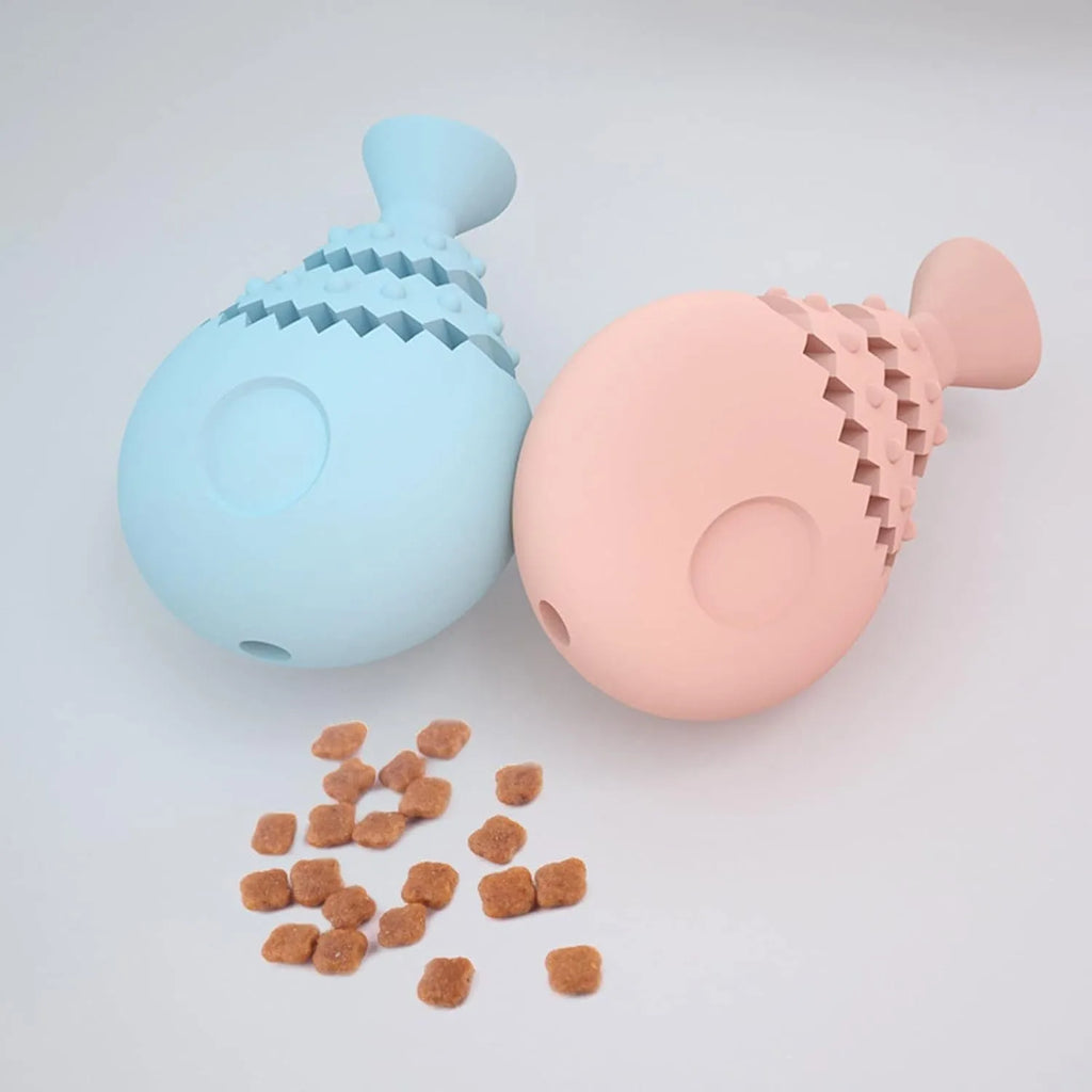 Blue, green, and pink rubber fish bone shaped dog chew toy with hollow centre for treats.