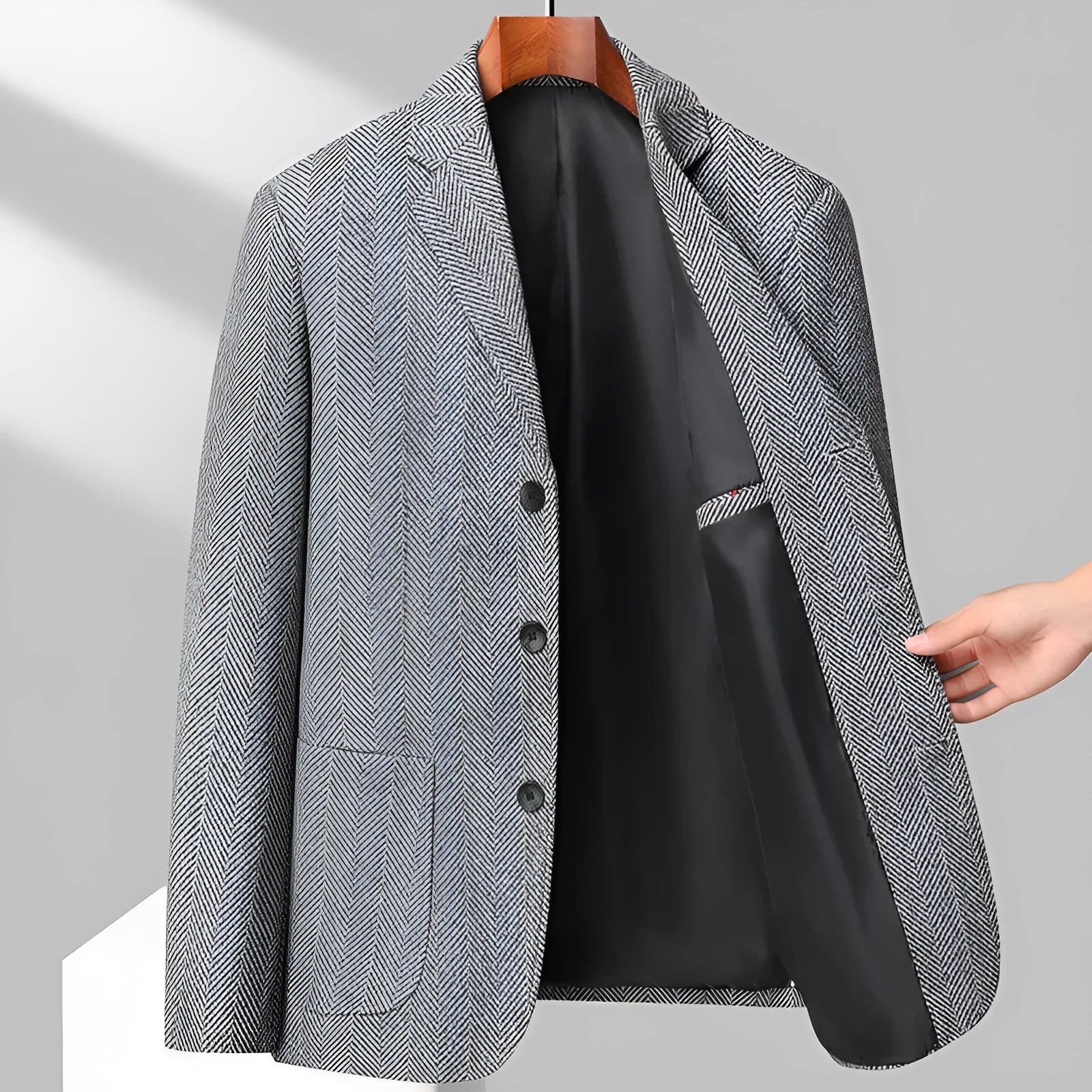 Loose-fit men's woolen coat in black, shown on a model for casual spring or autumn wear.