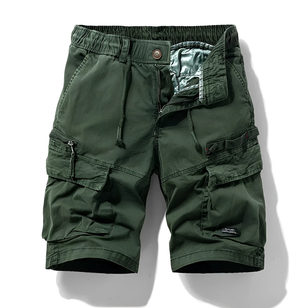 Men's army green cotton shorts with zipper and multiple pockets, shown on a hanger.