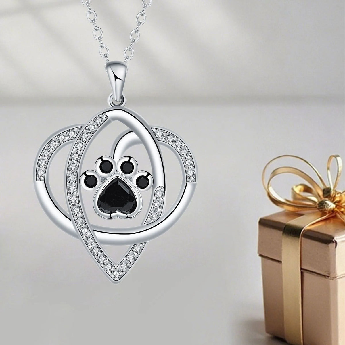 Close-up of a dog's paw print pendant necklace on a cross chain for women.