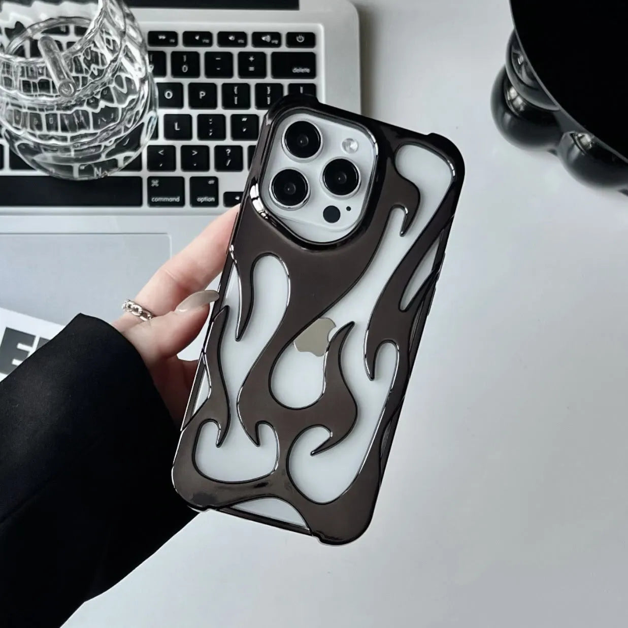 Electroplated iPhone case with hollow flame pattern design in gold, black, purple, and silver finishes