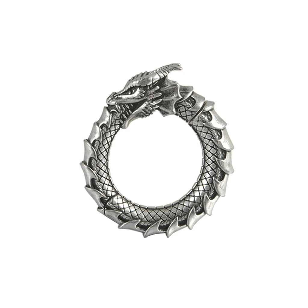 A pair of large, geometric dragon-shaped hollow out earrings in an antique silver colour.