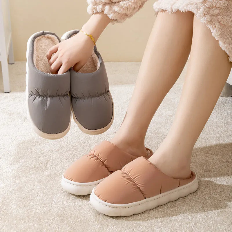 A pair of down cotton slippers with an artificial leather upper and thick rubber sole, shown in blue.