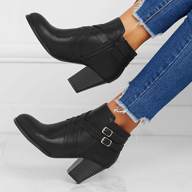 Plus size women's short ankle boots with a 7cm block heel, side zipper, and belt buckle detail in black.