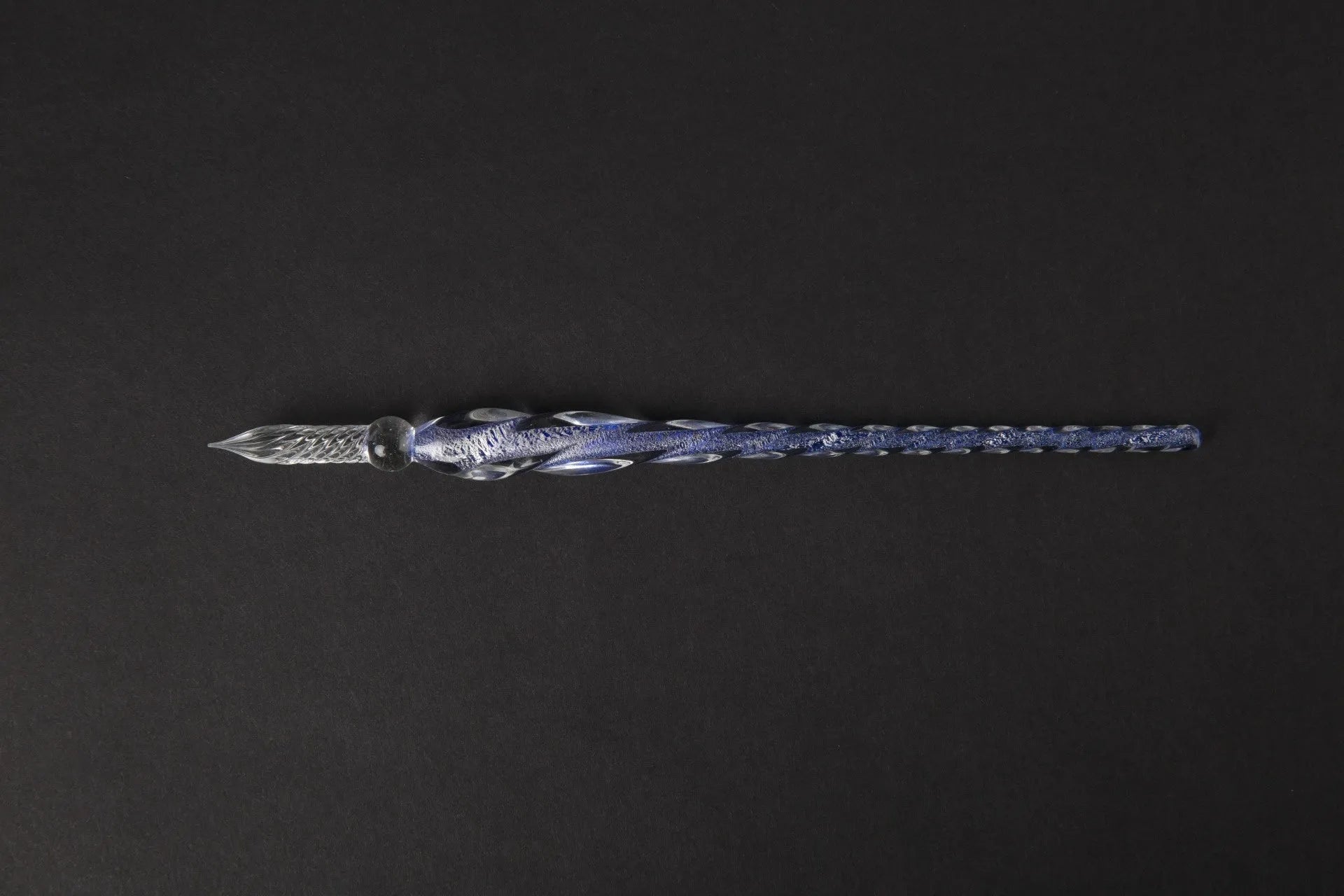 Transparent glass crystal pen with coloured ink visible inside, abstract modelling design