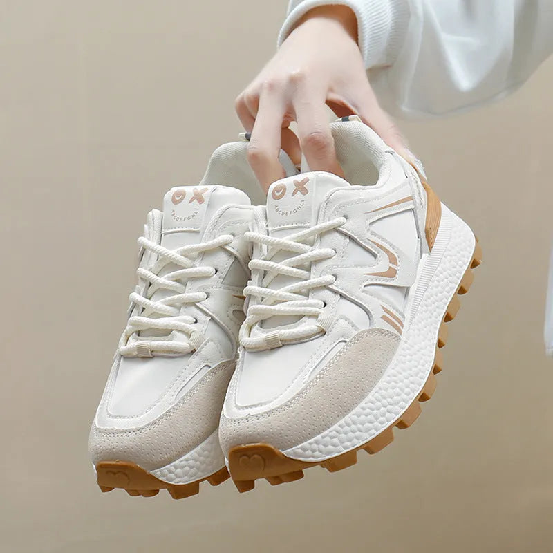 Women's black platform casual lace-up trainers with a round toe and flat heel on a white background.