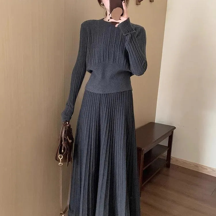 Women's knitted ethnic style dress suit with skirt showing 3D patterns in dark grey colour