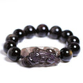 Geometric Pi Xiu charm on a polished icy obsidian crystal bracelet for men and women.