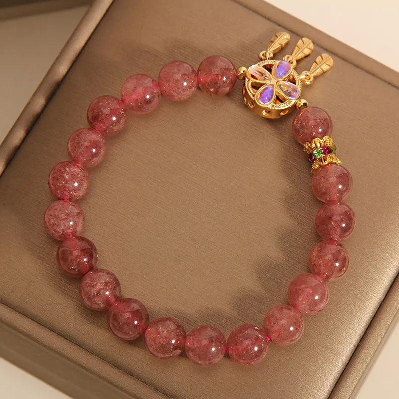 Women's bracelet with a strawberry quartz dream catcher ball pendant on a crystal chain.