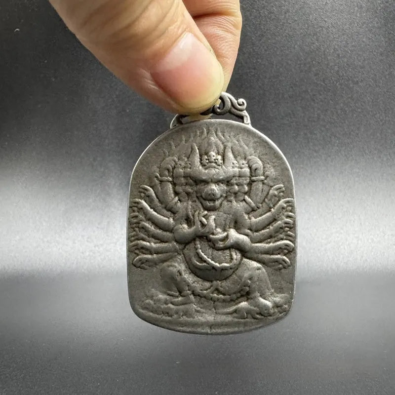 Close-up of iron Chinese style geometric pendant ornament featuring Aryaacalanatha Yamantaka motif.