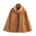 Women's long black coat with a detachable grey artificial fur collar, showing longline silhouette and side pockets.