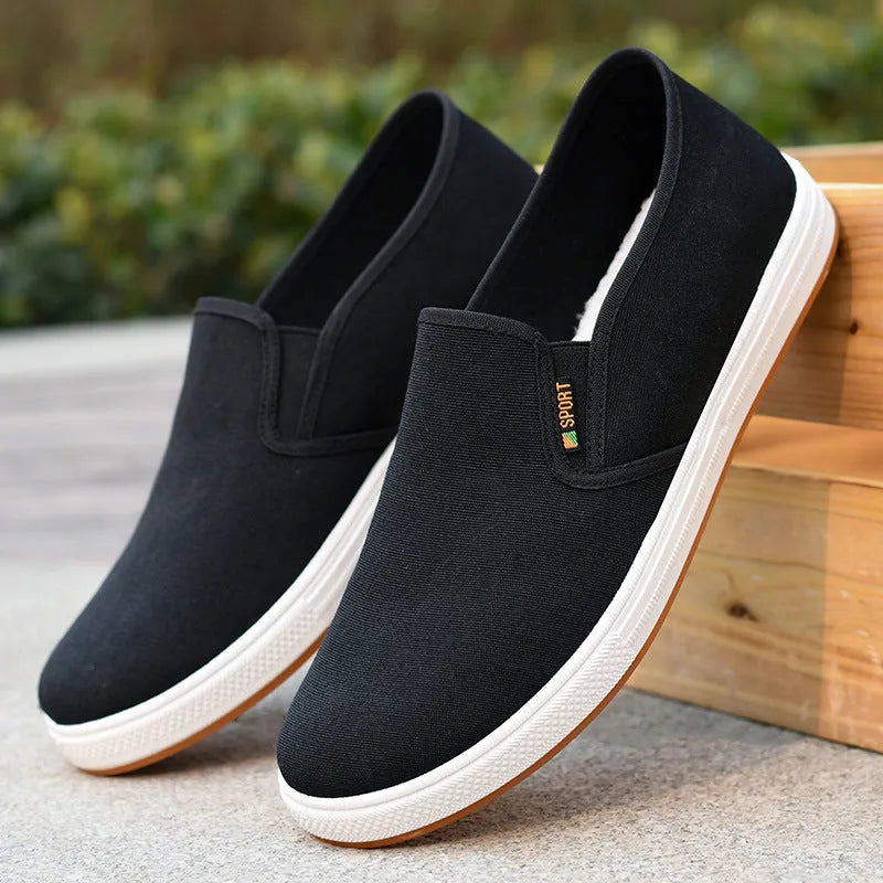 Men's black canvas slip-on shoes with round toe and shallow mouth design