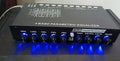 Black car audio EQ amplifier with control panel showing frequency knobs and channel indicators