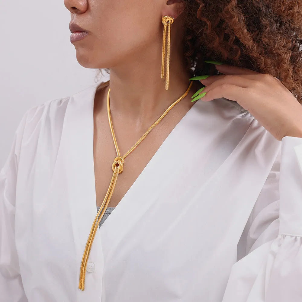 Gold titanium steel necklace with knotted tassel pendant and matching earrings set