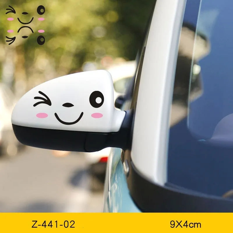 A pair of reflective cartoon car eye stickers on a vehicle body.
