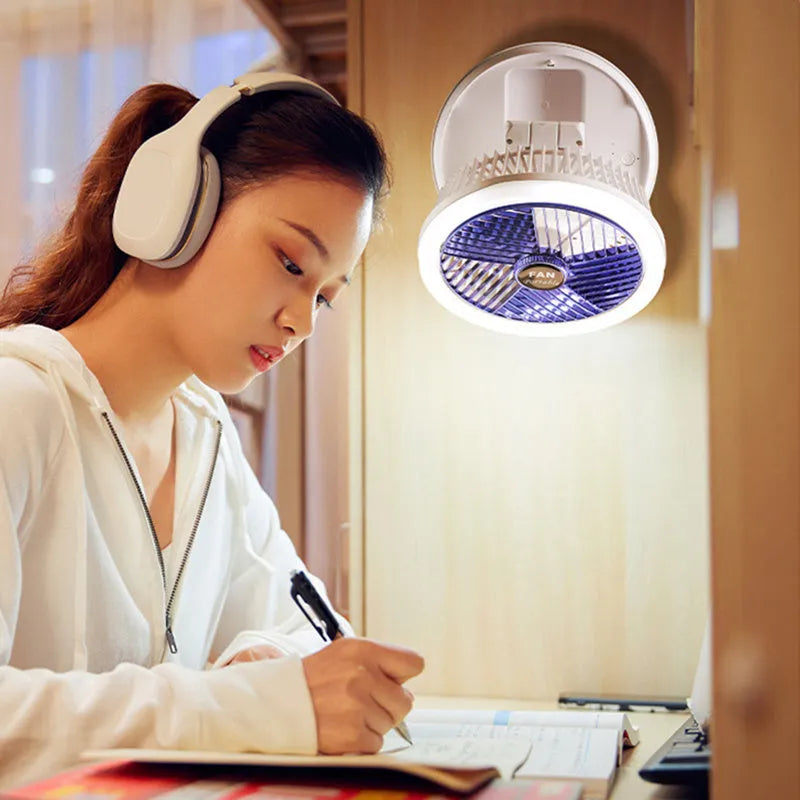 Blue foldable USB desk fan with LED light shown in open position on a table