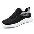 Women's low-top black mesh sneakers with a round toe and white PVC sole on a plain background.