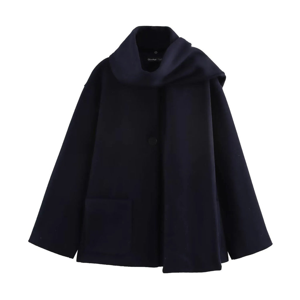 Women's long black coat with a detachable grey artificial fur collar, showing longline silhouette and side pockets.