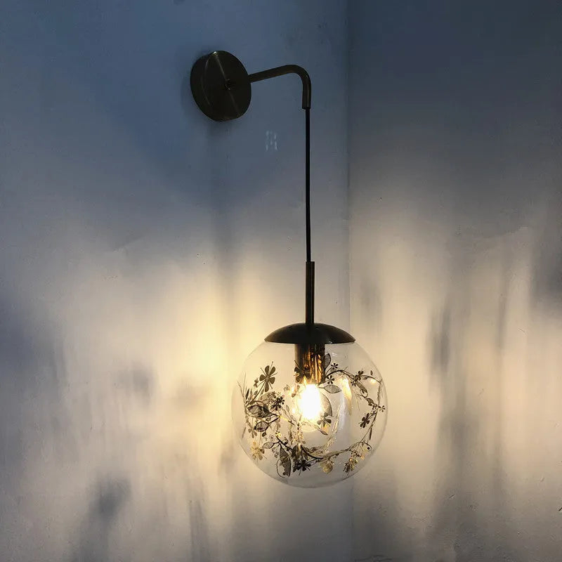 Glass wall lamp with floral pattern in choice of golden or silver finish
