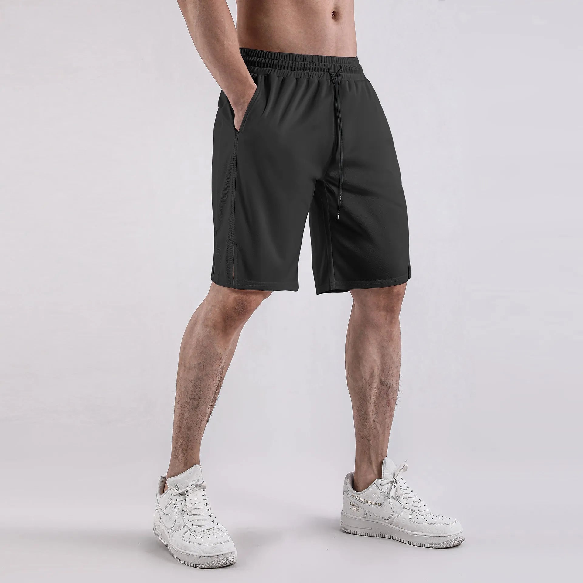 Men's black quick-dry mesh shorts with elastic waist, shown in a loose, casual fit.