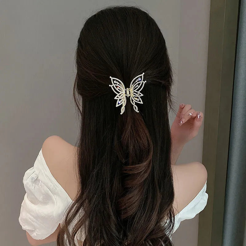 Butterfly-shaped alloy hair clip for women with electroplated finish, shown in rhinestone and pearl styles.