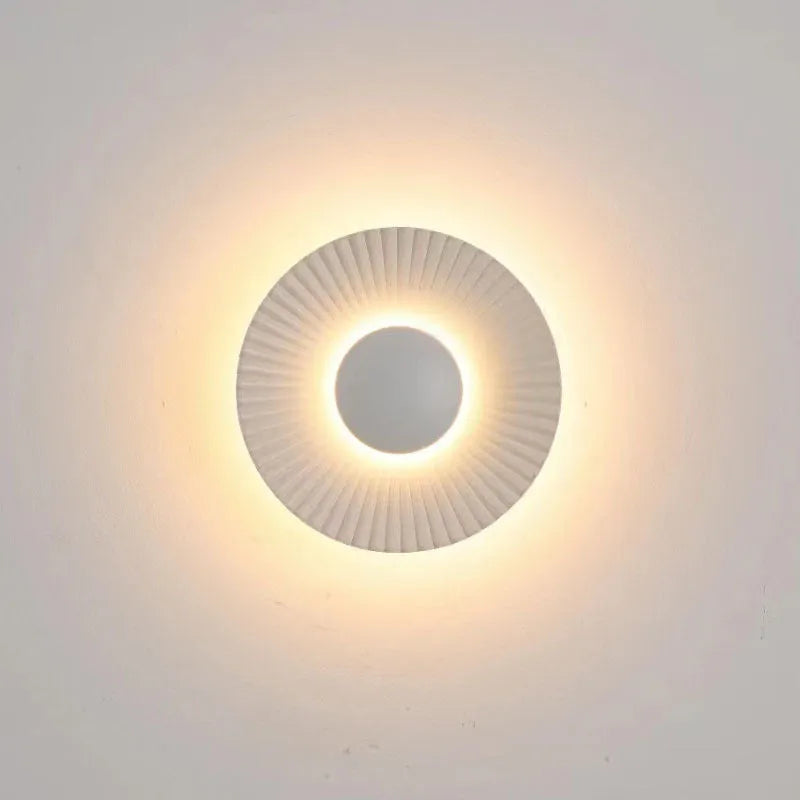 Round aluminium wall lamp with LED light in various colour options including white and gold variants