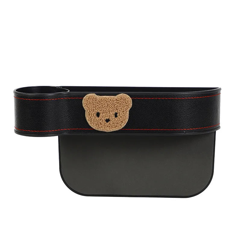 Leather car seat gap storage box with cartoon bear design for organising phones and keys.